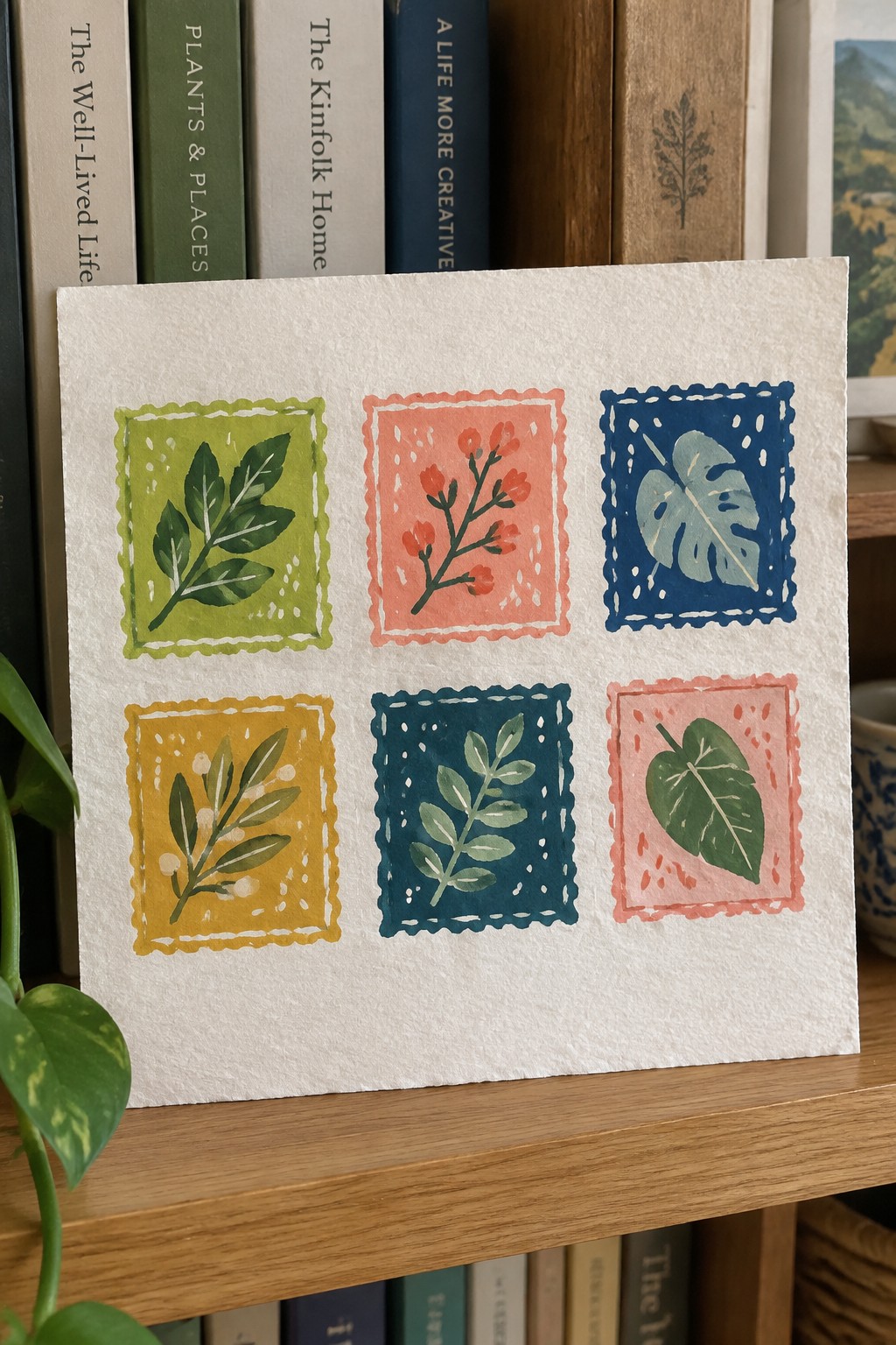 Six colorful watercolor plant stamps with scalloped borders on white paper