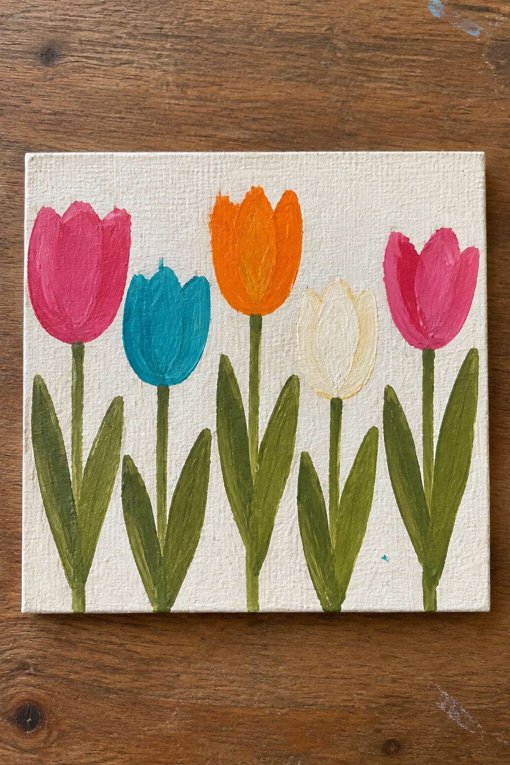 Five colorful tulips in pink, teal, orange, white on canvas with green stems