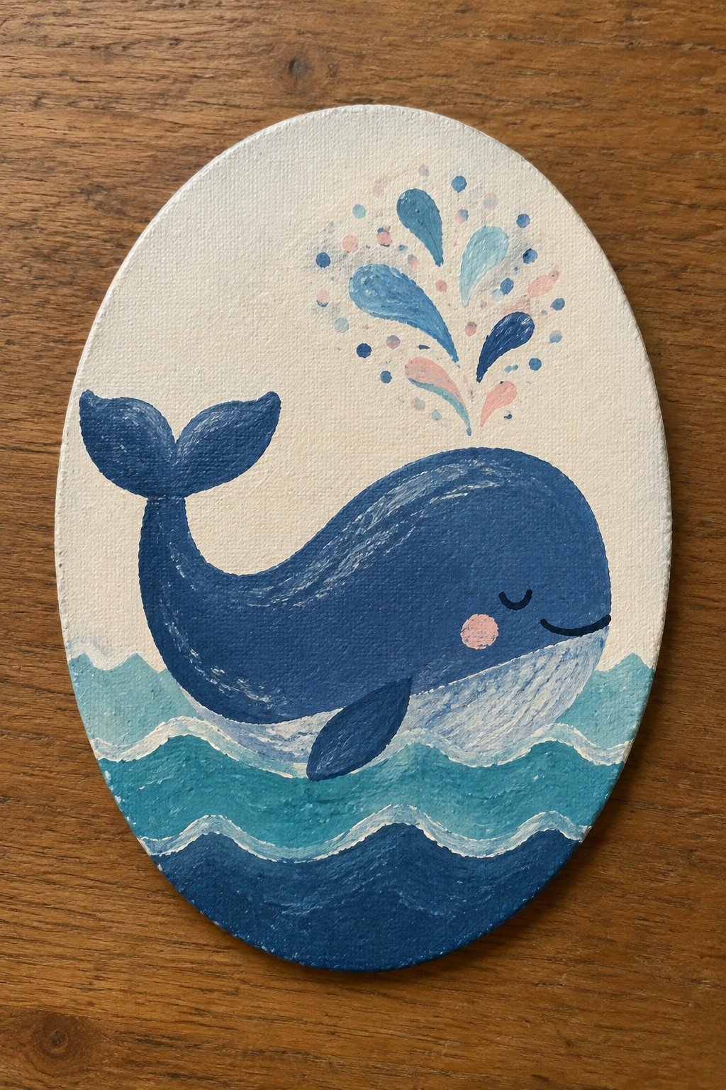 Cute blue whale with closed eyes and pink cheek in teal waves on oval canvas