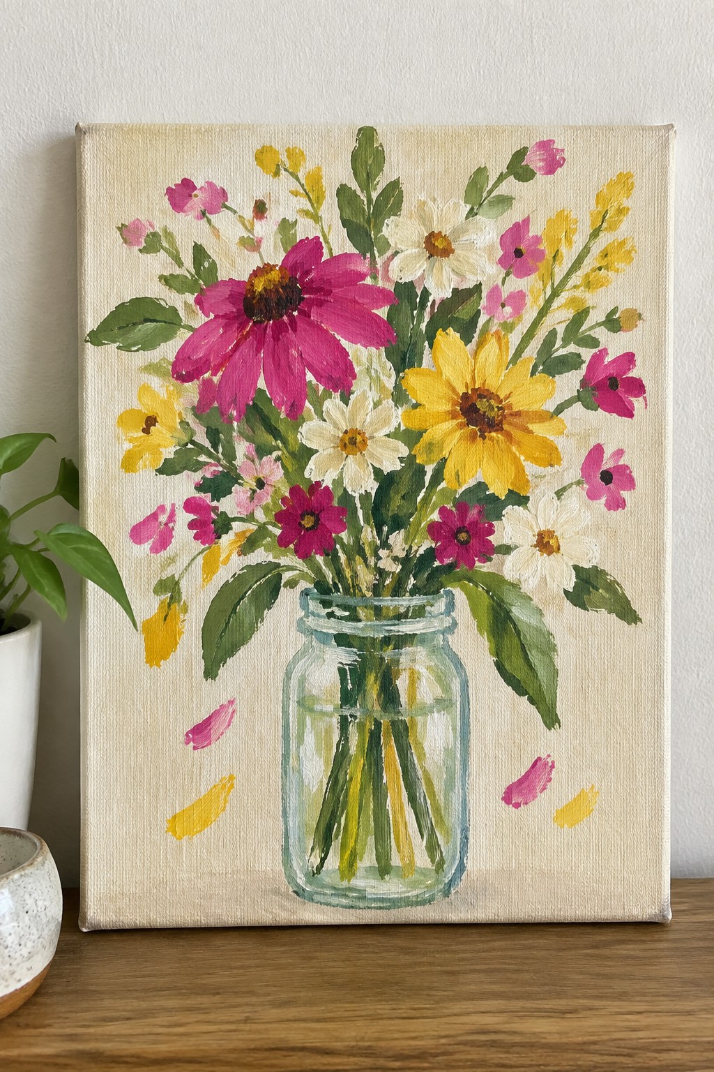 Colorful painting of pink, yellow, and white flowers in a glass mason jar