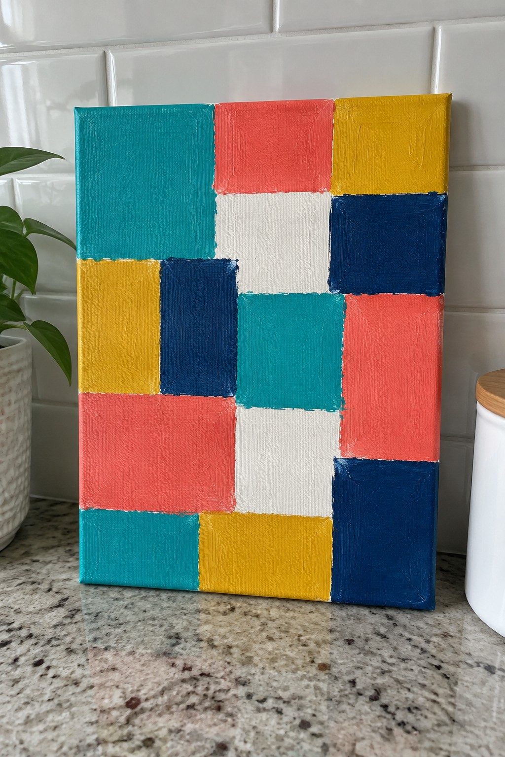 A canvas with colorful squares and rectangles in teal, red, yellow, navy, white, and pink arranged in an offset grid pattern.