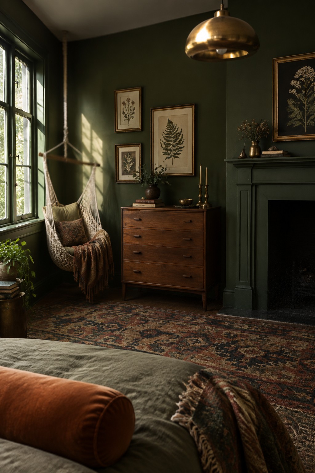 Cozy dark green bedroom with hanging chair, wooden dresser, fireplace, and patterned rug.