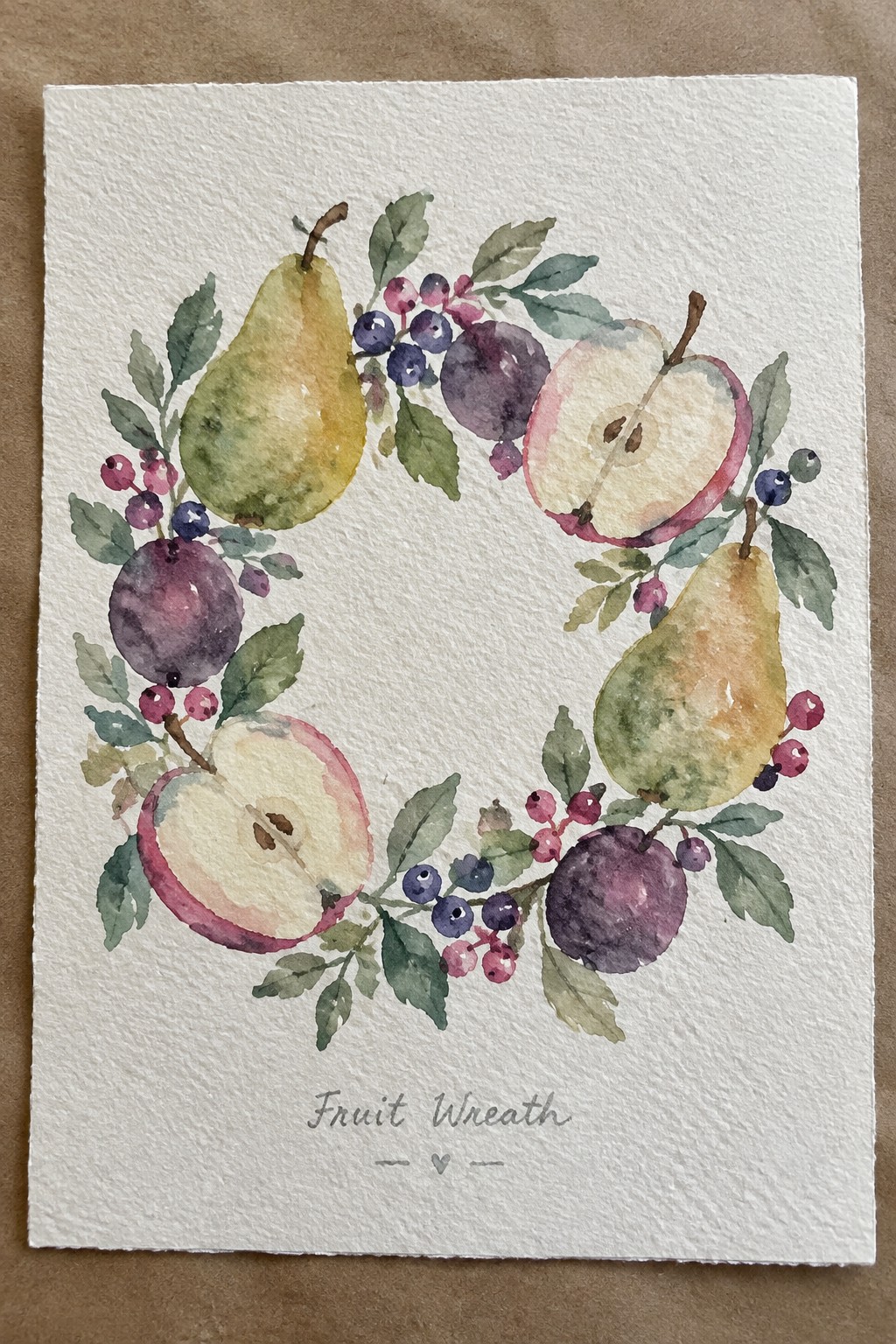 Watercolor painting of a circular fruit wreath with pears, apples, plums, and berries on white paper.