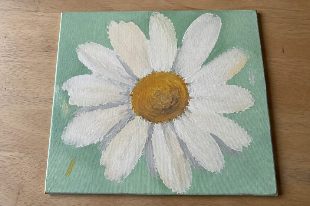 22 Easy Acrylic Painting Ideas for Beginners Featuring Simple Floral Motifs A painted white daisy with a yellow center on a light green canvas.