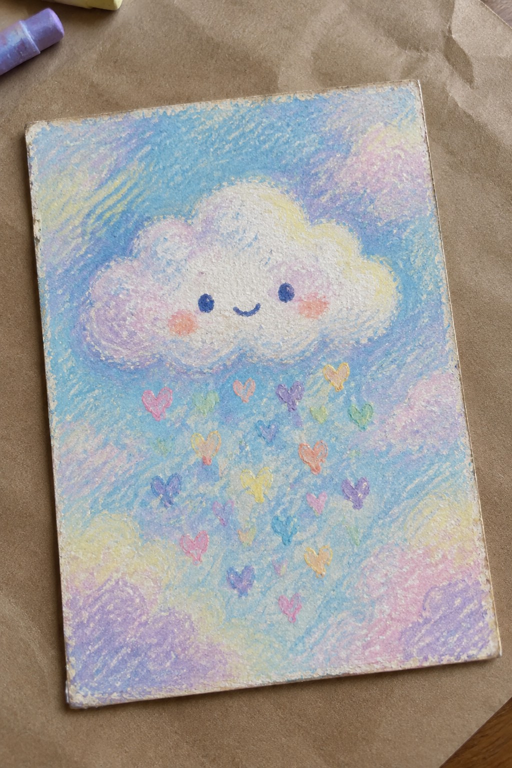 Pastel chalk drawing of smiling cloud raining colorful hearts in blue sky