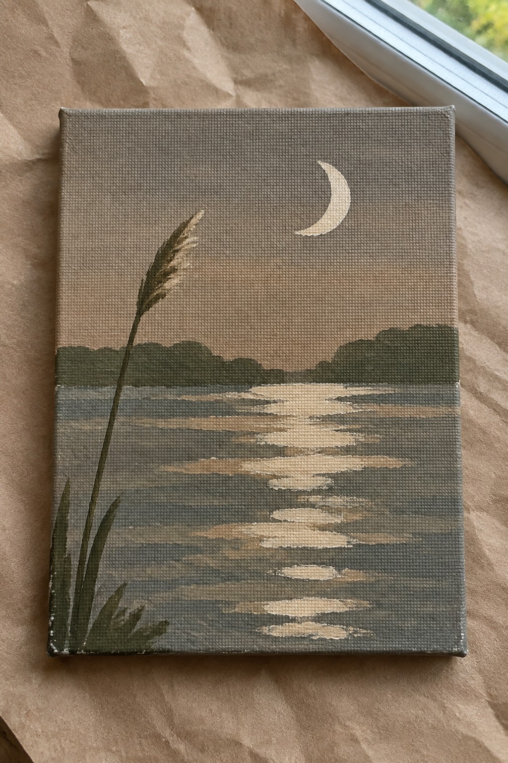 Minimalist painting of crescent moon reflecting on calm water, hills, and tall grass