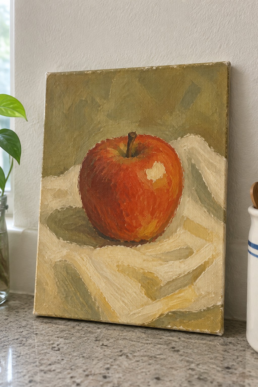 Oil painting of shiny red apple on wrinkled white fabric with green backdrop