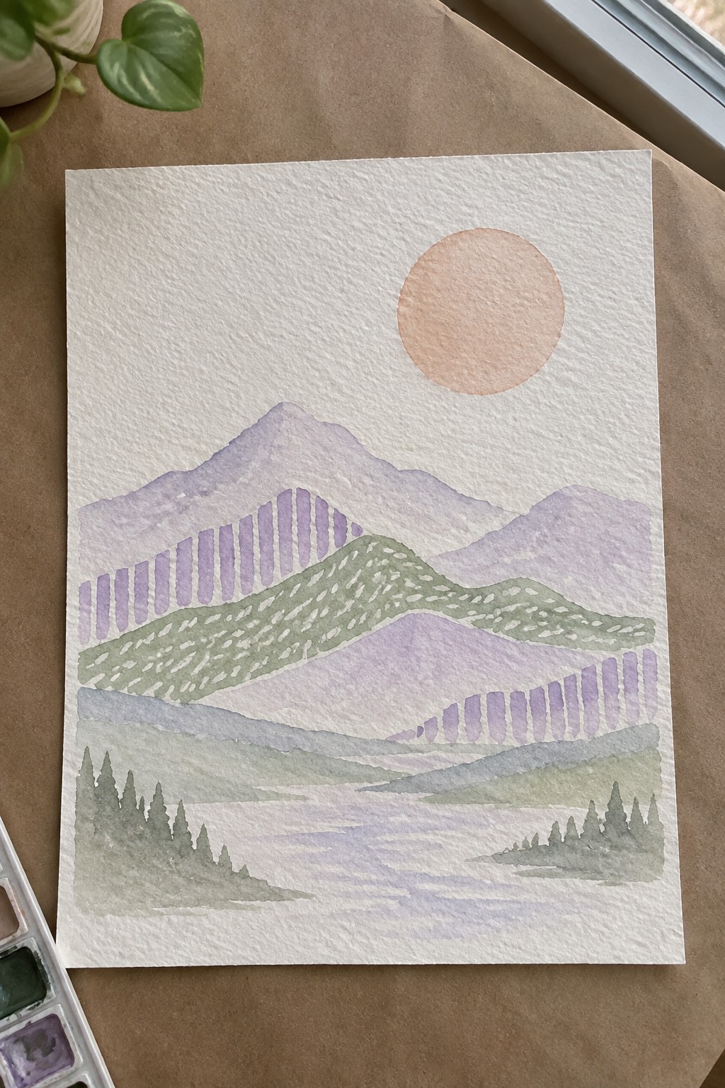 Watercolor landscape of layered purple mountains, green hills, peach sun, and pine trees.