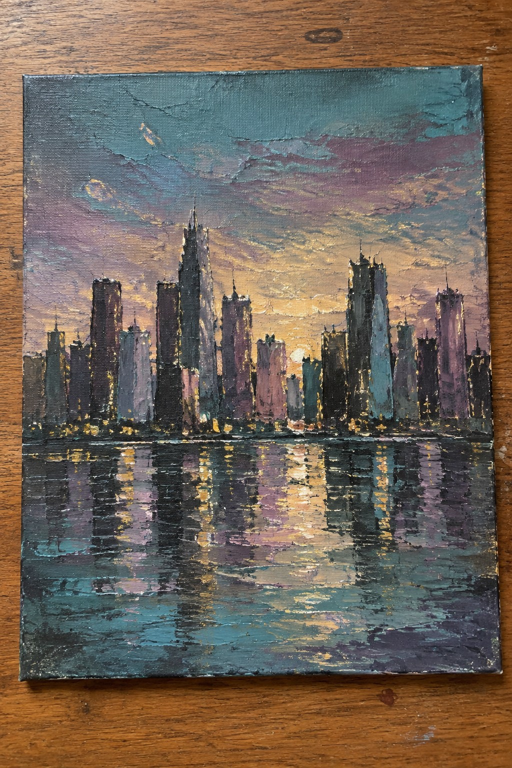 Textured painting of a vibrant city skyline reflected in water at sunset