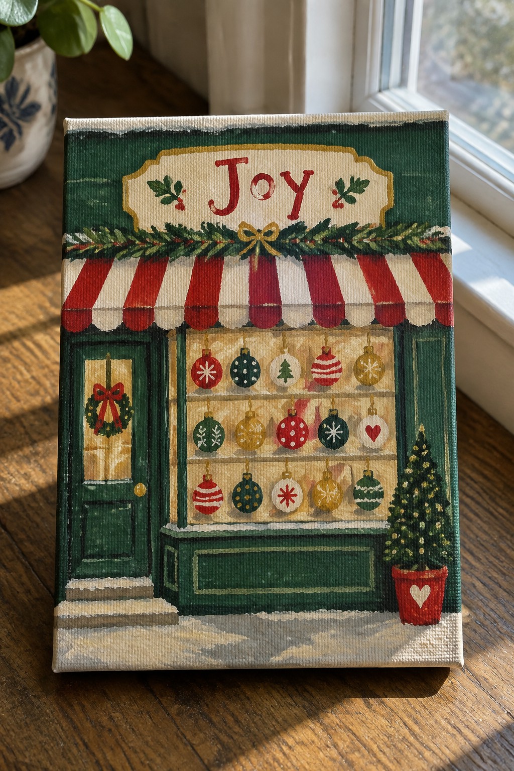Canvas painting of green Christmas shop with red awning, ornaments, and