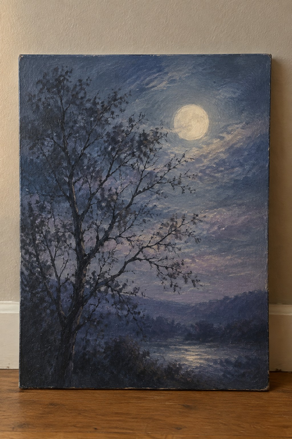 Moonlit night sky with full moon, bare tree, purple clouds, and distant hills