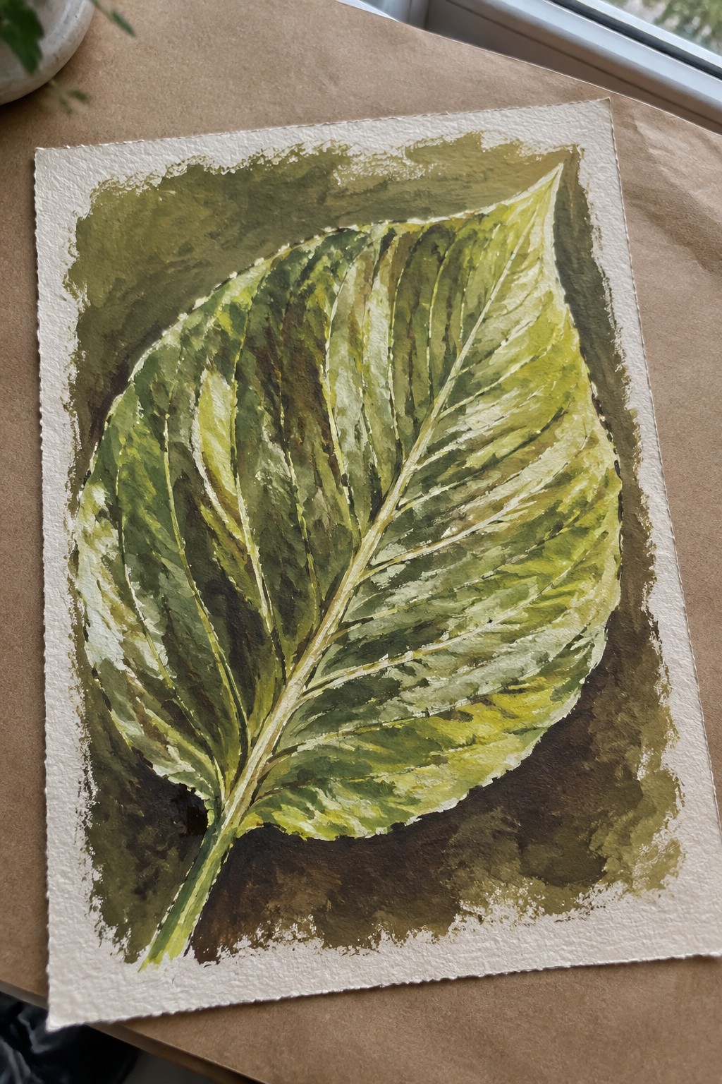 Watercolor painting of large green leaf with prominent veins on white paper.