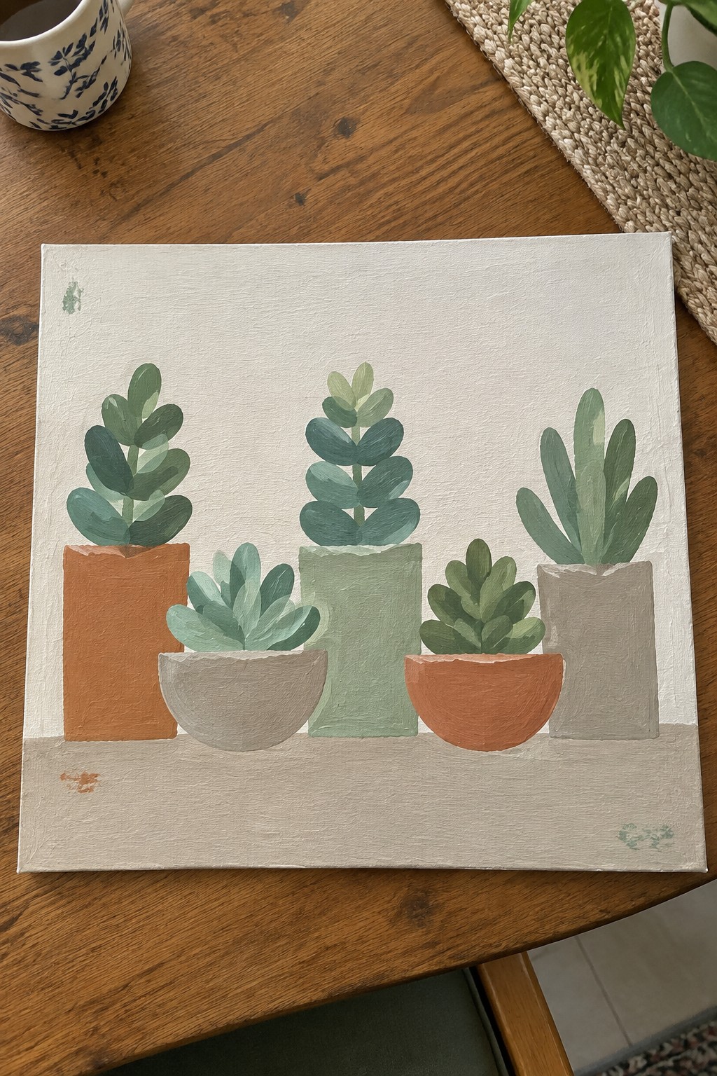 Painting of five succulents in terracotta, gray, and green pots on canvas.