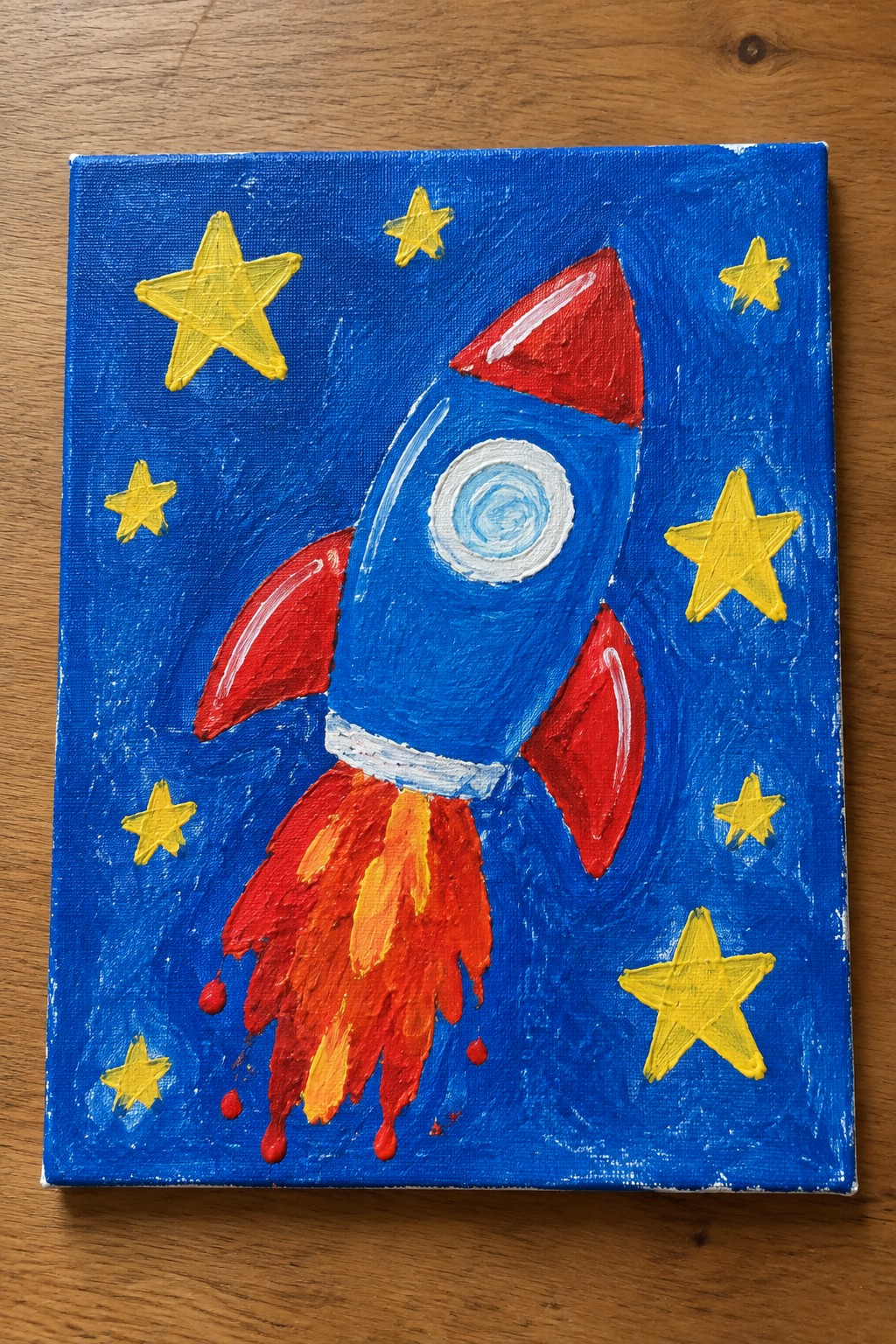 Blue rocket with red fins launching amid yellow stars on blue canvas