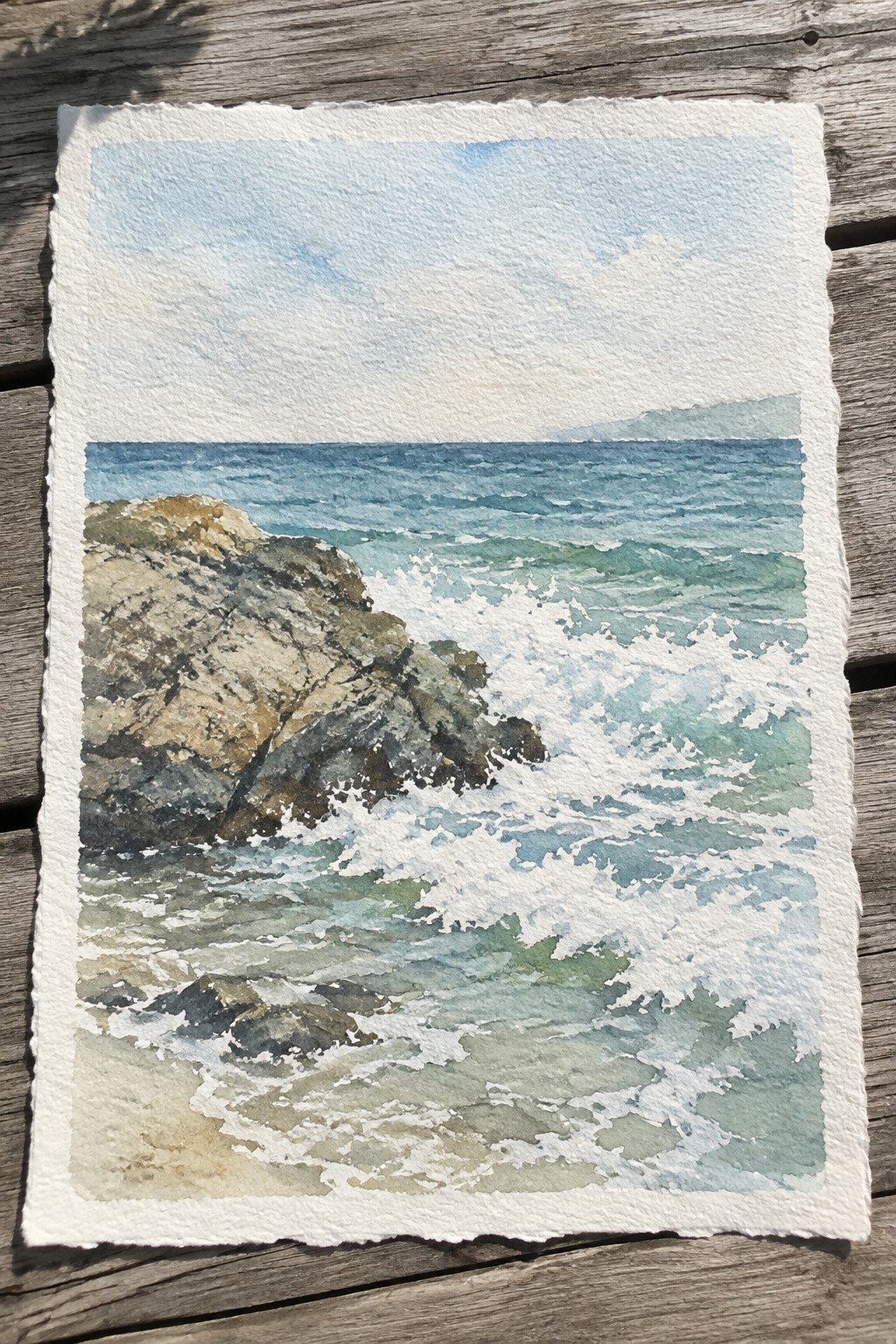 Watercolor seascape of turquoise waves crashing on jagged rocks under blue sky