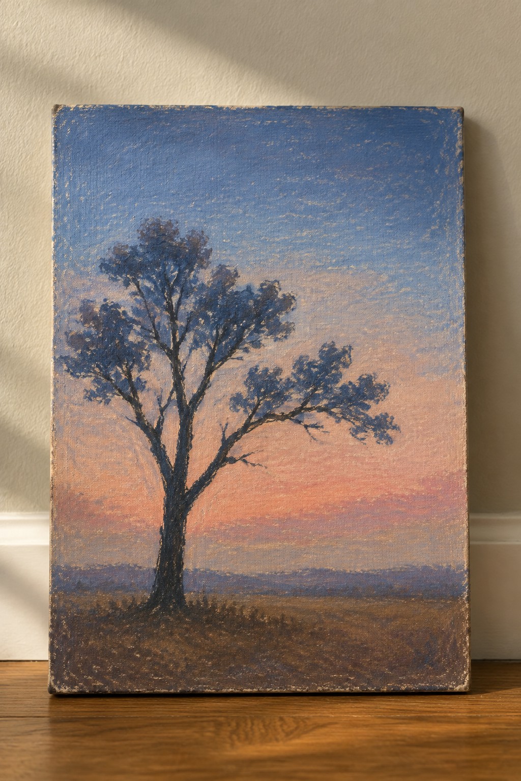 Solitary tree silhouetted against vibrant blue-to-pink sunset sky in oil painting