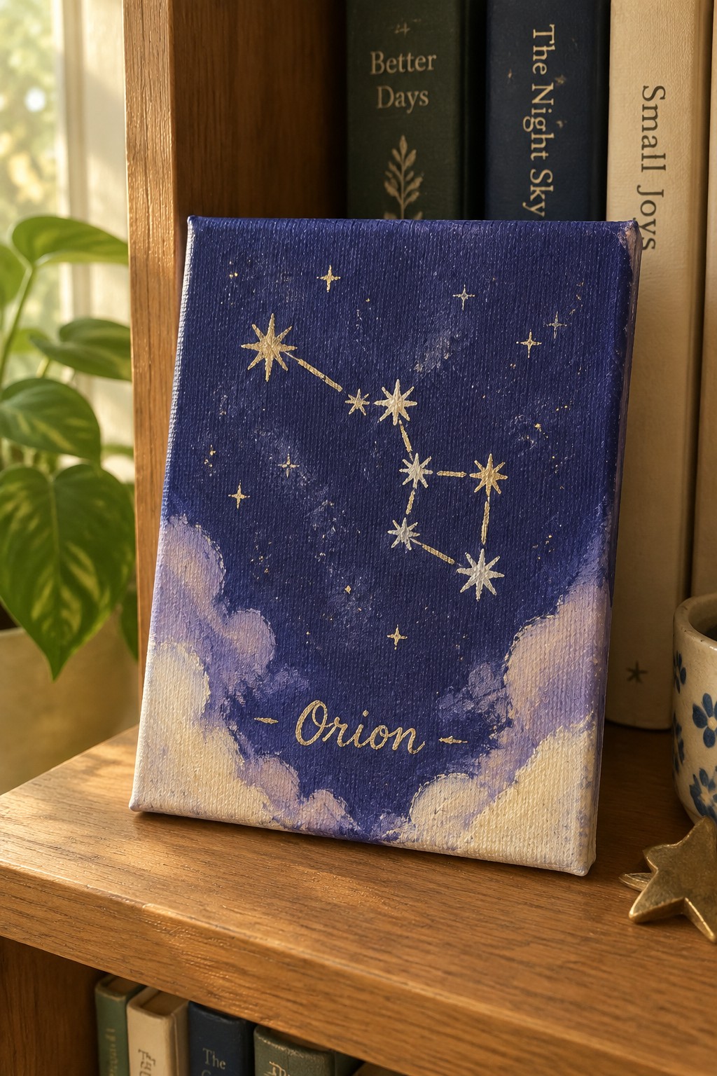 Orion constellation in gold stars on deep blue canvas with purple clouds below