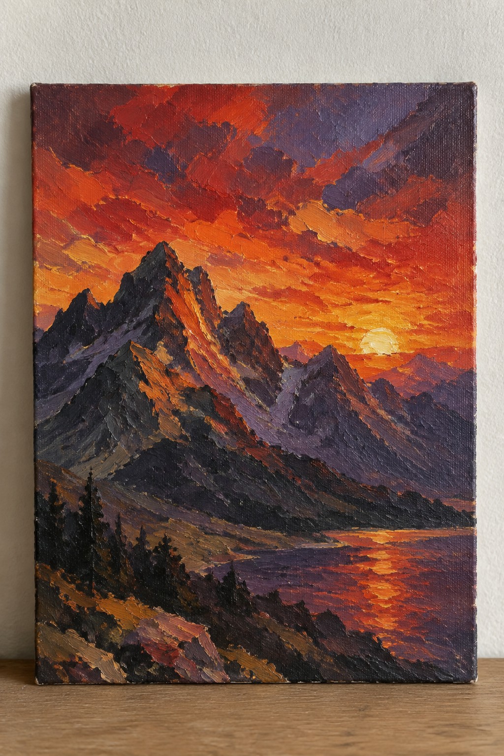 An oil painting of jagged mountains at sunset with a bright sun low on the horizon, orange and red clouds, and dark foreground trees.