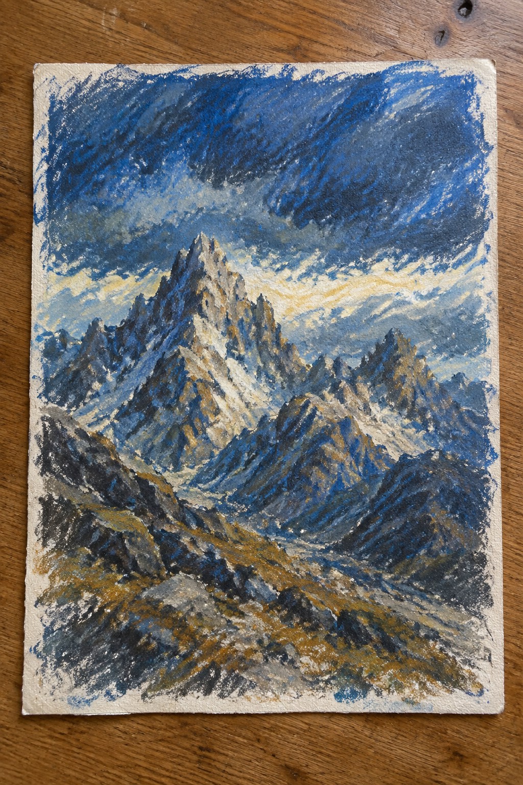 Textured painting of jagged snow-capped mountains beneath dramatic blue and golden clouds