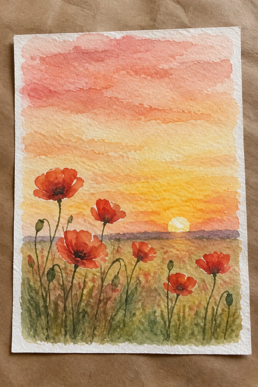 Watercolor painting of red poppies in a golden field under a vibrant sunset sky